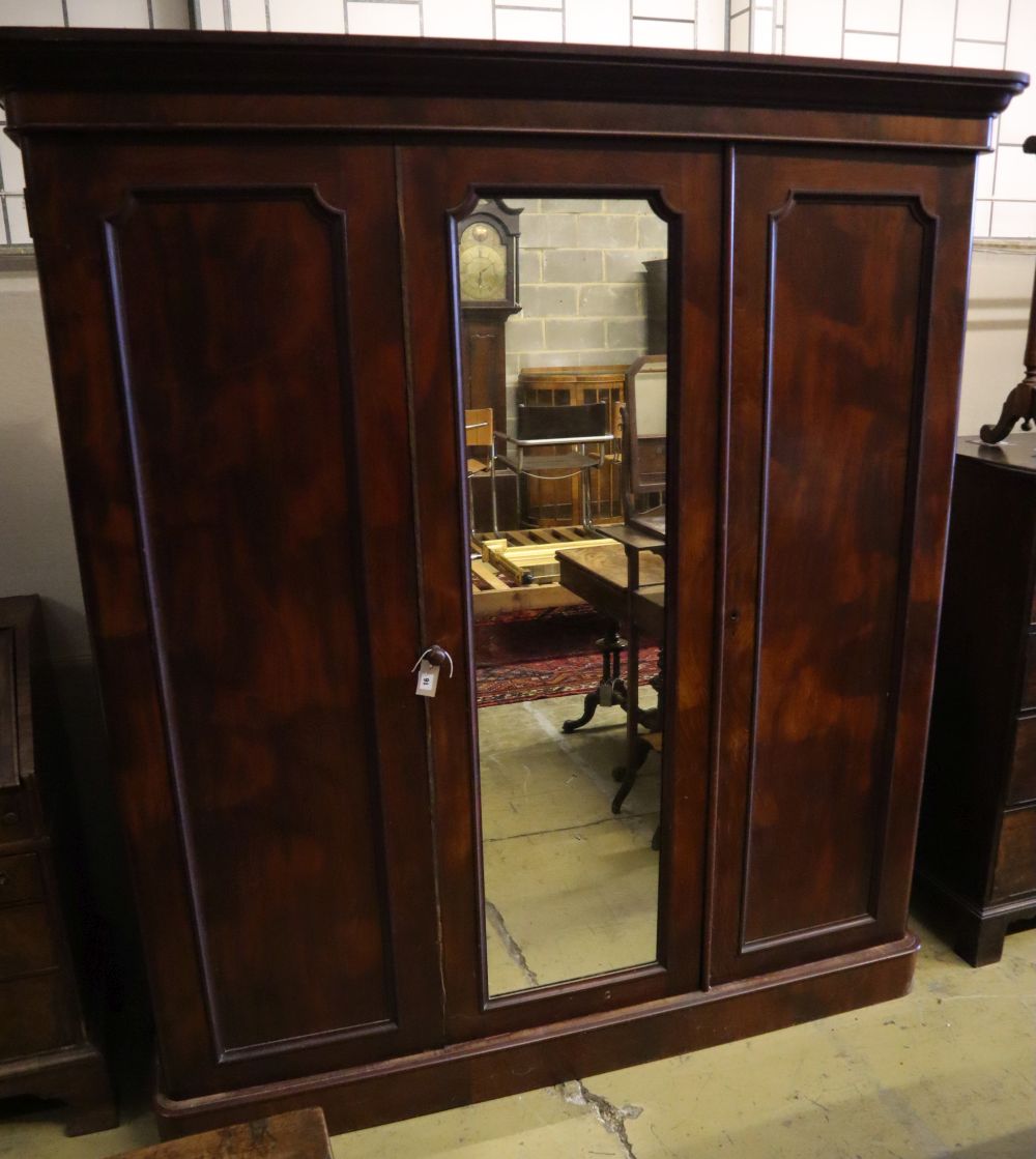 A Victorian mahogany three door wardrobe, with a central mirrored door, width 190cm depth 60cm height 208cm